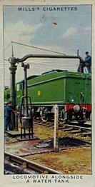 1938 Wills's Railway Equipment #7 Locomotive alongside a Water Tank Front