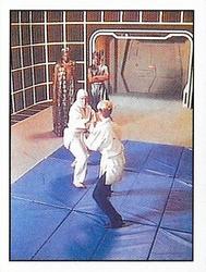 1987 Panini Star Trek: The Next Generation Stickers #62 Yar demonstrating martial arts to Lutan and Hagon on holodeck Front