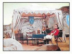 1987 Panini Star Trek: The Next Generation Stickers #215 Q, as Napoleonic Marshall, sitting next to campaign tent Front