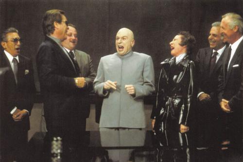 1998-99 Panini Austin Powers Photocards #46 Dr. Evil entertains the Suits Front
