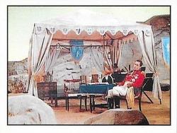 1992 Panini Star Trek: The Next Generation Stickers (Red backs) #215 Q, as Napoleonic Marshall, sitting next to campaign tent Front