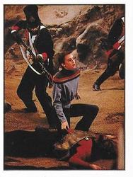 1992 Panini Star Trek: The Next Generation Stickers (Red backs) #228 Wesley kneeling by Worf, a soldier stabbing him in the back Front