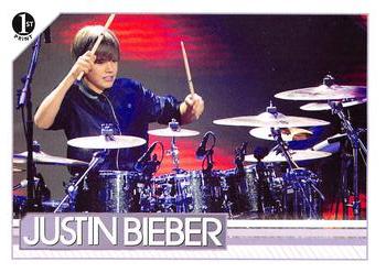 2010 Panini Justin Bieber #19 Pulling out a pair of drumsticks during his pe Front